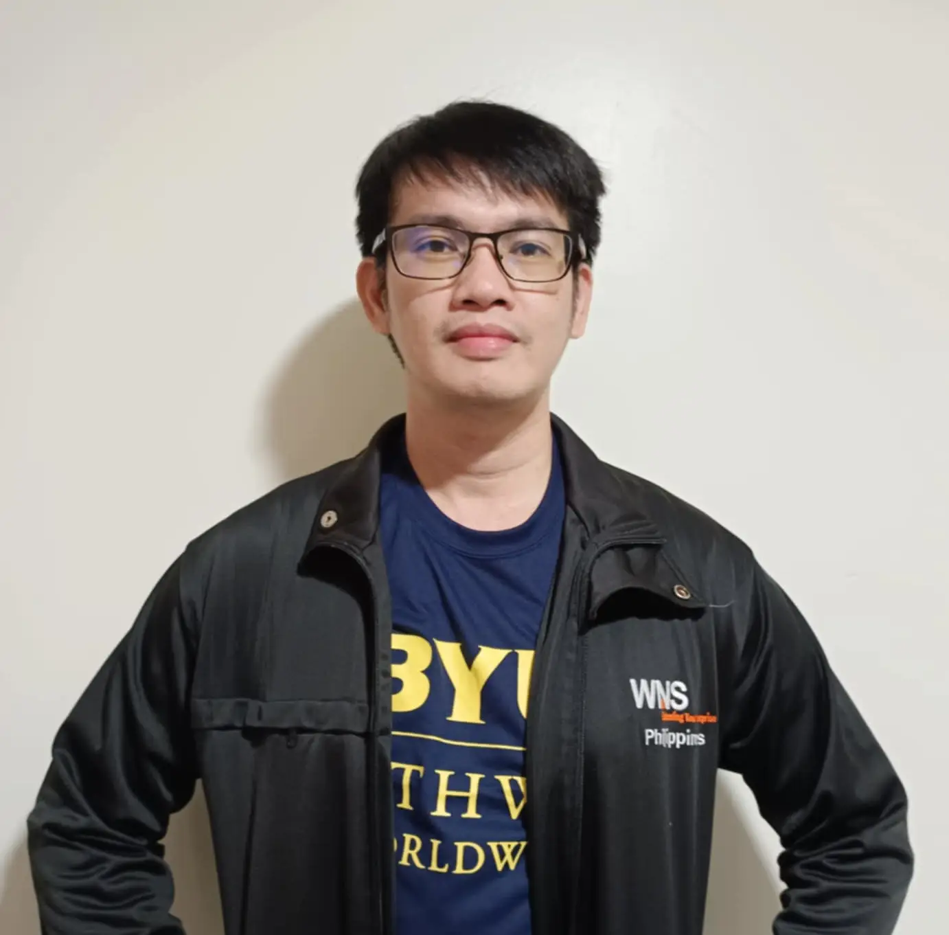 A solo picture of James De Guzman wearing a WNS jacket and BYU shirt